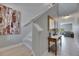 Hallway featuring stairs, a console table, and a glimpse into the bright living room at 15718 Fort Island Pl, Sun City Center, FL 33573