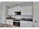 Updated kitchen features white cabinets, stainless appliances and granite countertops at 15718 Fort Island Pl, Sun City Center, FL 33573