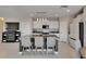 Modern kitchen island with granite countertops, stainless steel appliances, and seating for three at 15718 Fort Island Pl, Sun City Center, FL 33573