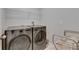 This contemporary laundry room features new front-load washer and dryer, and overhead storage at 15718 Fort Island Pl, Sun City Center, FL 33573