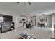 View of open concept living space with modern fireplace, kitchen, and dining table at 15718 Fort Island Pl, Sun City Center, FL 33573