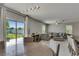 Bright living room with sliding glass doors to the backyard and a comfortable sectional sofa at 15718 Fort Island Pl, Sun City Center, FL 33573