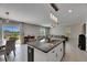 Living area showcasing the island, dining, living room, and outdoor access at 15718 Fort Island Pl, Sun City Center, FL 33573