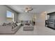 Comfortable living room featuring a sectional couch, ottoman, and modern fireplace at 15718 Fort Island Pl, Sun City Center, FL 33573