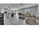 Open floorplan with an island kitchen, adjacent dining area, and cozy living space with a comfortable sofa at 15718 Fort Island Pl, Sun City Center, FL 33573