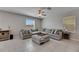 Spacious living room features a large sectional sofa and bright natural light at 15718 Fort Island Pl, Sun City Center, FL 33573