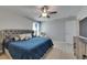 Spacious main bedroom featuring a ceiling fan, large bed, and bright decor at 15718 Fort Island Pl, Sun City Center, FL 33573