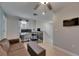 A well lit area features a desk setup with dual monitors, complemented by a cozy couch and ample natural light at 15718 Fort Island Pl, Sun City Center, FL 33573