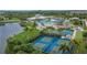Pickleball courts surrounded by palm trees next to a playground, swimming pools and a community center at 15718 Fort Island Pl, Sun City Center, FL 33573
