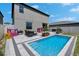 A backyard paradise with a refreshing pool, outdoor dining area, and playful playhouses at 15718 Fort Island Pl, Sun City Center, FL 33573