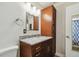 Bathroom featuring marble countertop vanity, white toilet, and wood cabinet at 16169 Gardendale Dr, Tampa, FL 33624