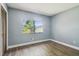 Empty bedroom features laminate flooring and a large window at 16169 Gardendale Dr, Tampa, FL 33624