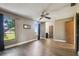 Open floor plan of bedroom includes a ceiling fan, natural light, and wood-look floors throughout at 16169 Gardendale Dr, Tampa, FL 33624