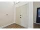 Home entryway featuring wood floors, double door closet, and view into the living room at 16169 Gardendale Dr, Tampa, FL 33624