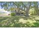 Inviting home with a well-manicured lawn and mature trees, creating a picturesque setting at 16169 Gardendale Dr, Tampa, FL 33624