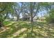 Charming home nestled amidst mature trees, offering a serene and shaded front yard at 16169 Gardendale Dr, Tampa, FL 33624