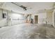 Functional garage area features a water heater, utility sink, and shelving units at 16169 Gardendale Dr, Tampa, FL 33624