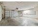 Spacious garage with concrete floor and attached shelving provides ample storage space at 16169 Gardendale Dr, Tampa, FL 33624