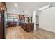 Modern kitchen with stainless steel appliances, an island, dark wood cabinets, and wood floors at 16169 Gardendale Dr, Tampa, FL 33624