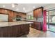 Modern kitchen with stainless steel appliances, dark wood cabinets, tile backsplash, and granite countertops at 16169 Gardendale Dr, Tampa, FL 33624