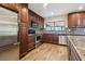 Modern kitchen with stainless steel appliances, granite countertops, and wood cabinets at 16169 Gardendale Dr, Tampa, FL 33624