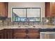 Kitchen sink features granite countertops, stainless steel appliances, and wood cabinets at 16169 Gardendale Dr, Tampa, FL 33624