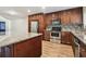 Spacious kitchen features stainless steel appliances, granite countertops, and wood cabinets at 16169 Gardendale Dr, Tampa, FL 33624