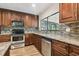Modern kitchen features stainless steel appliances, tile backsplash, and a large window at 16169 Gardendale Dr, Tampa, FL 33624