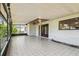 The screened patio features a ceiling fan and tile flooring that opens to the backyard at 16169 Gardendale Dr, Tampa, FL 33624