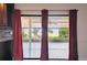 View from the kitchen, looking out onto a screened patio and green backyard at 16169 Gardendale Dr, Tampa, FL 33624
