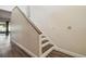 Carpeted staircase features wood trim and leads to the upper level of the home at 16169 Gardendale Dr, Tampa, FL 33624