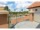 Balcony view with a pool and palm trees under a bright blue sky at 1695 Pinellas Bayway S # E6, St Petersburg, FL 33715