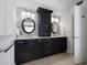 Bright bathroom featuring a double sink vanity with dark cabinets and a tile accent wall at 1695 Pinellas Bayway S # E6, St Petersburg, FL 33715