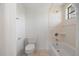 A clean and well-maintained bathroom featuring tiled walls, a bathtub, and an efficient toilet at 1695 Pinellas Bayway S # E6, St Petersburg, FL 33715