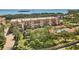 Beautiful multi-story condo with balconies, lush landscaping, and an inviting community pool, offering a luxurious coastal lifestyle at 1695 Pinellas Bayway S # E6, St Petersburg, FL 33715