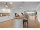 A spacious kitchen with white cabinetry and a breakfast bar that opens to the living area at 1695 Pinellas Bayway S # E6, St Petersburg, FL 33715