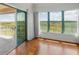 Bright living room features hardwood floors and sliding glass doors that lead to the balcony at 1695 Pinellas Bayway S # E6, St Petersburg, FL 33715