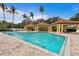 Relaxing community pool featuring cabanas, lounge chairs, and clear water, all surrounded by lush tropical landscaping at 1695 Pinellas Bayway S # E6, St Petersburg, FL 33715