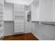 Walk-in closet with custom shelving and drawers provide ample storage and organization at 1695 Pinellas Bayway S # E6, St Petersburg, FL 33715