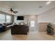 Spacious living room featuring a ceiling fan, large window, comfortable seating and carpeted floors at 18345 Fish Loop, Land O Lakes, FL 34638