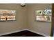 Well-lit bedroom with wood flooring and two windows that allow for natural light at 1837 Pasadena Dr, Dunedin, FL 34698