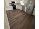 Updated kitchen with stainless steel appliances, granite countertops, and wood flooring at 1837 Pasadena Dr, Dunedin, FL 34698