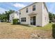 Large grassy backyard featuring a sliding glass door at 18837 Litzau Ln, Land O Lakes, FL 34638
