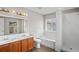 Bathroom featuring double sinks, a soaking tub, and a separate shower at 18837 Litzau Ln, Land O Lakes, FL 34638