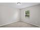 Bedroom with neutral walls, carpet, and a bright window for natural light at 18837 Litzau Ln, Land O Lakes, FL 34638