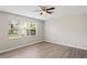Bright, airy bedroom with modern floors, neutral walls, and large windows providing natural light at 18837 Litzau Ln, Land O Lakes, FL 34638