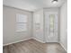 Bright entryway features modern floors, a decorative glass door, and natural light from two windows at 18837 Litzau Ln, Land O Lakes, FL 34638