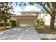Charming two-story home featuring a two-car garage, manicured landscaping, and a welcoming entrance at 18837 Litzau Ln, Land O Lakes, FL 34638