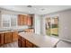 Open-concept kitchen with a center island, wood cabinetry, and a sliding door to the backyard at 18837 Litzau Ln, Land O Lakes, FL 34638