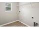 Convenient laundry room with wood-look flooring and utility connections at 18837 Litzau Ln, Land O Lakes, FL 34638